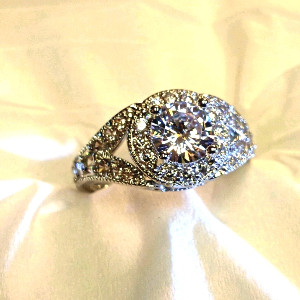 Brilliant cut white sapphire with cubics
